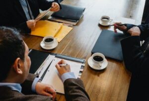 A group of people sitting at a table with coffee.